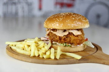 Fried Chicken Burger Sandwich with Fries on a Wooden Dish