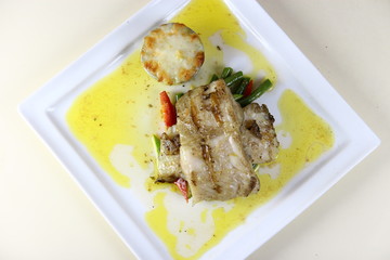 Steamed Fish Steak with Mash Potatoes and Vegies on a ceramic plate