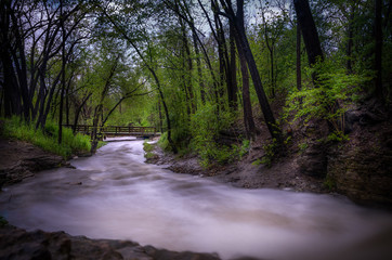 wooden bridge over running stream