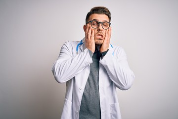 Young doctor man with blue eyes wearing medical coat and stethoscope over isolated background Tired hands covering face, depression and sadness, upset and irritated for problem