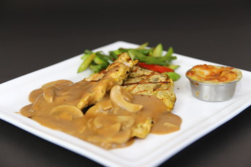 Grilled Chicken Fillet Steak with Mushroom sauce served on a white plate