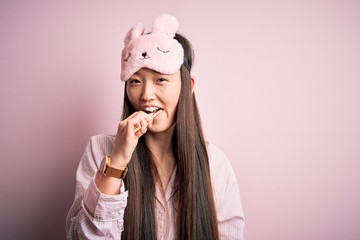 Young beautiful asian woman wearing pajama brushing her teeth using tooth brush and oral paste, cleaning teeth and tongue as healthy health care morning routine