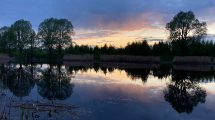 sunset on a summer evening on the pond