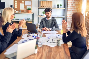 Group of business workers smiling happy and confident. Working together with smile on face applauding one of them at the office
