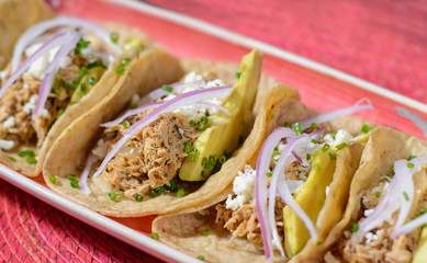 Tacos with pork, avocado and onion