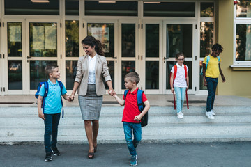 Mother taking her sons home from school.