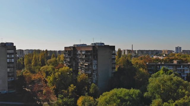 View from the height of the city on the roofs of houses, treesz in the cloudy sky
