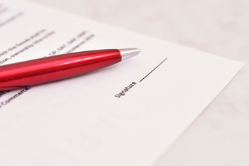document blank with red pen and space for signature.