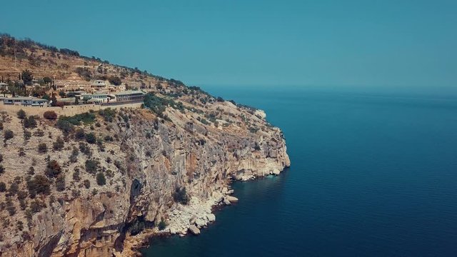 Areal view of cliff at sea with town and curch in Thassos in Greece
