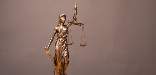 Legal and law concept statue of Lady Justice with scales of justice.