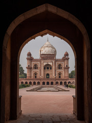 shot of safdarjung's tomb framed by an arch in delhi