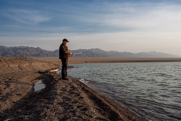 fisherman on the lake with spinning