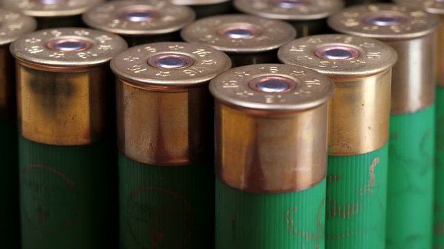 Closeup weathered green ammo cartridges for modern firearm stacked together in rows