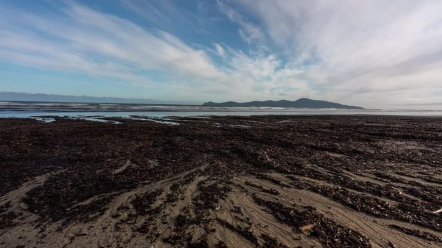 Time Lapse on the beach looking out to Kapiti Island in New Zealand sliding from left to right