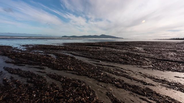 Time Lapse on the beach looking out to Kapiti Island in New Zealand sliding from left to right