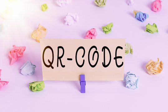 Conceptual hand writing showing Qr Code. Concept meaning the trademark for a type of matrix barcode A machinereadable code Colored crumpled paper empty reminder white floor clothespin