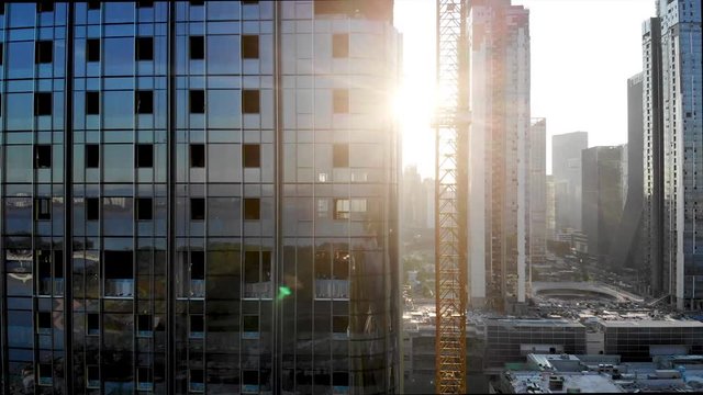 Workers are Building High-rise and Installing the Precast Glass Panel on The Construction Site in Shenzhen Bay. Cladding of the Building by Curtain Walls.