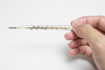 A hand holding a thermometer  on a white background