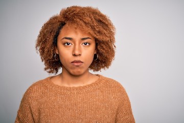 Young beautiful African American afro woman with curly hair wearing casual sweater with a confident expression on smart face thinking serious