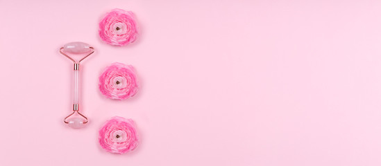 Jade roller with ranunculus flowers on pink drop. Beauty time, selfcare, beauty log, feminine...