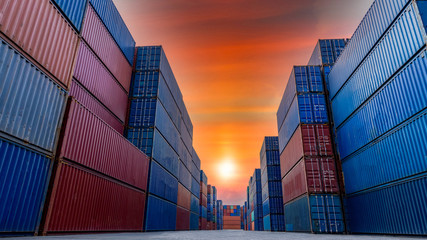 Industrial container yard for business commercial trade logistic transportation oversea worldwide Import Export, Stack of colorful cargo freight ship container at sunset background.