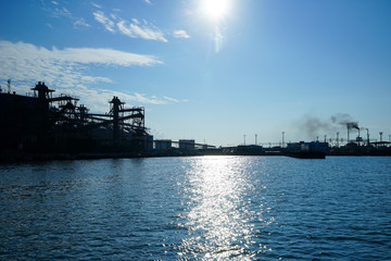 Silhouette of industrial structures in the background of the sea