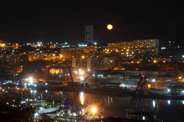Fototapeta na wymiar Night landscape with a yellow moon over the Bay