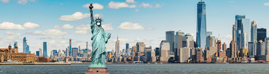 The Statue of Liberty wearing surgical mask when Covid-19 Outbreak over panorama of New york cityscape river side