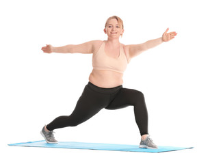 Woman with excess weight practicing yoga on white background