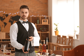 Waiter with bottle of wine at the restaurant