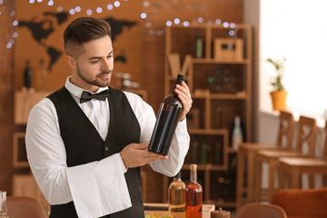 Waiter with bottle of wine at the restaurant