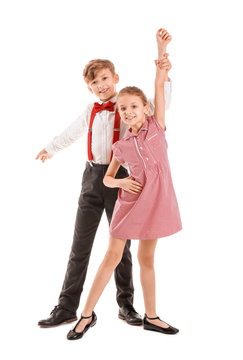 Cute little children dancing against white background