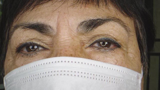 Close-up Of Older Woman's Face While Wearing Protective Face Mask