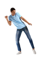African-American teenager dancing and listening to music against white background