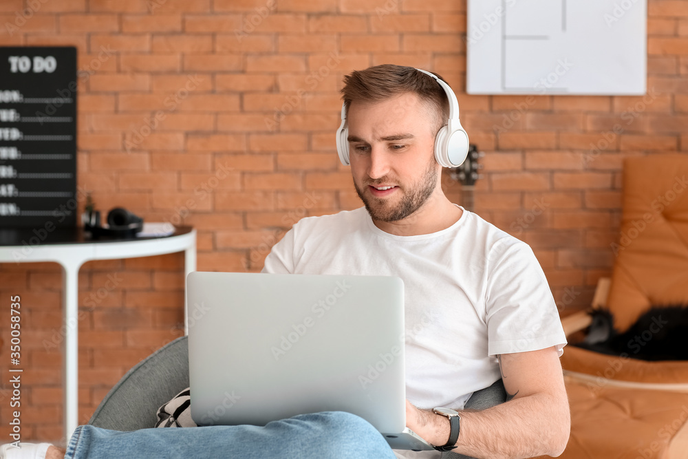 Sticker Young man with laptop working at home