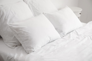 Big comfortable bed with clean linen in room