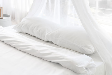 Soft white linen on bed © Pixel-Shot