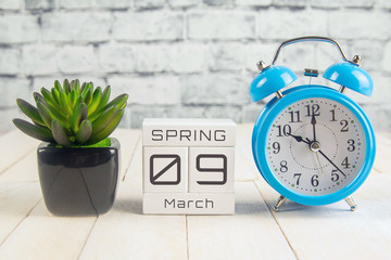 March 9 on the wooden calendar.The ninth day of the spring month, a calendar for the workplace....