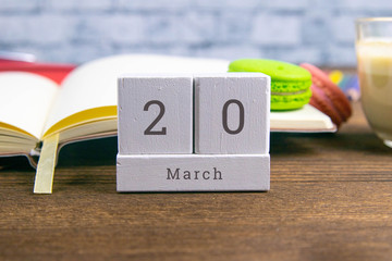 March 20 on the wooden calendar.The twentieth day of the spring month, a calendar for the workplace. Spring