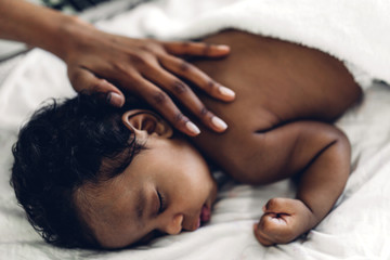 Portrait of enjoy happy love family african american mother playing with adorable little african american baby.Mom touching with cute son moments good time in a white bedroom.Love of black family 