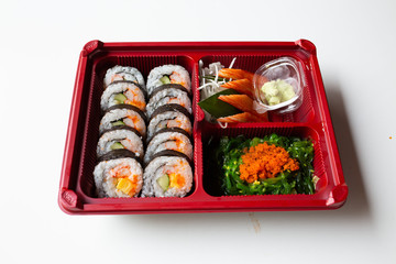 Japanese food put in a box placed on a white table