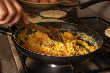 Home made arepas and eggs with onion and tomatoes. Typical colombian food criollo eggs