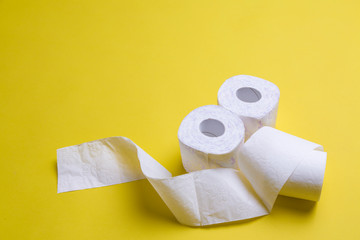 toilet paper rolls on yellow background. everyday objects in copy space. shortage of raw materials during period of coronavirus. a popular product on market. delivery of goods for house