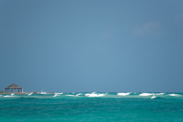 wonderful blue ocean with a cabin at the beach with blue sky