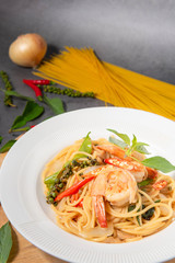 Drunken Spaghetti Shrimp in a White Plate, Black Background.