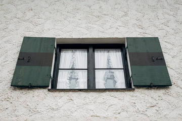 Green and black striped shuttered window of a traditional Bavarian house in Garmisch-Partenkirchen, Germany
