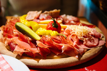A typical tyrolean mixed cold platter served on a wooden board
