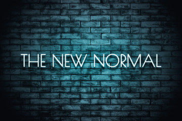 The New Normal. Neon light lettering  on brickwall background. New normal after covid-19 pandemic Background concept for poster, social network, banner, cards.