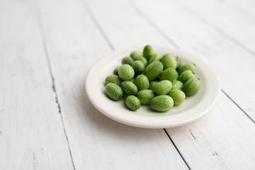 Freshly harvested cucamelons, Mexican sour gherkin pepquino or mouse melon. Sour grape size cucumbers. 