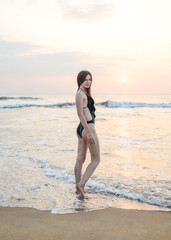 Fototapeta na wymiar a girl on a beach near the sea